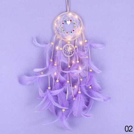 Purple dreamcatcher with feathers and lights on a light purple background