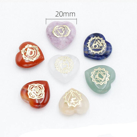Set of heart-shaped stones with gold symbols on a white background