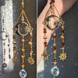 Decorative hanging ornament with celestial designs and beads on a textured background