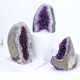 Three amethyst geodes on a white background