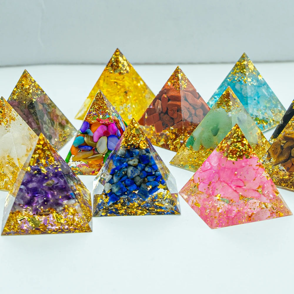 Colorful pyramid-shaped decorative items with embedded stones on a white background