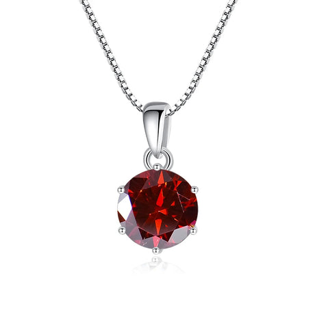 Red gemstone pendant on a silver chain against a white background