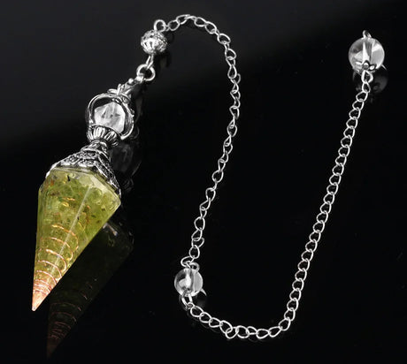 Crystal pendulum with chain on a black background