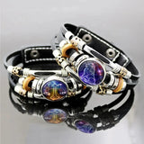 Multistrand bracelet with zodiac symbols on a reflective surface