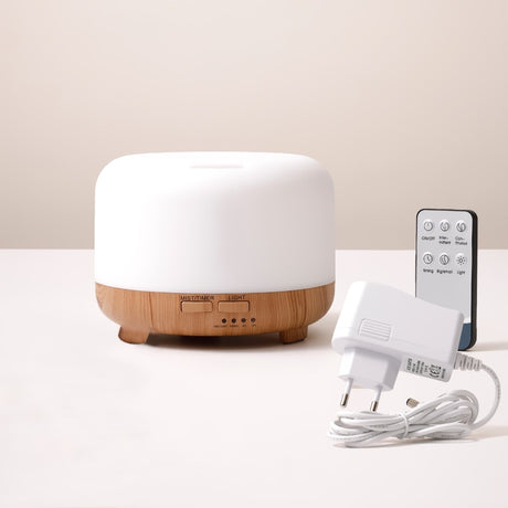White diffuser with wooden base and remote control on a light surface