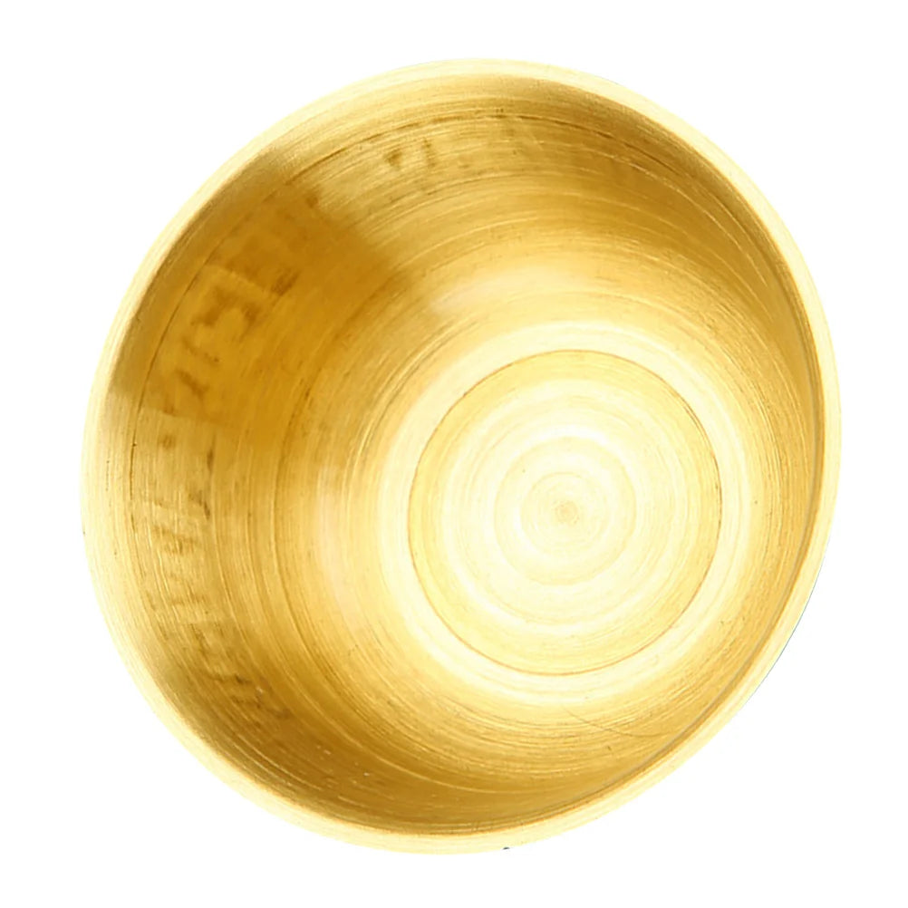 Gold bowl with concentric circular pattern on a white background