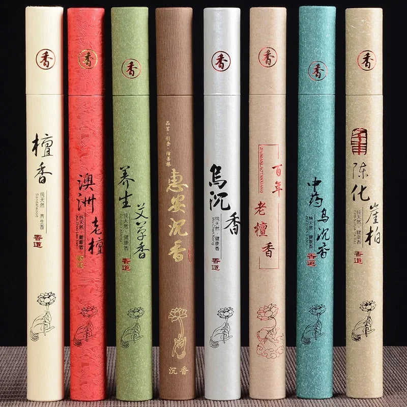 Set of incense sticks in various colored tubes with text and designs on a dark background
