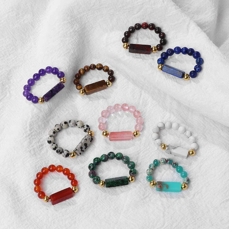 Collection of colorful beaded bracelets on a white fabric background