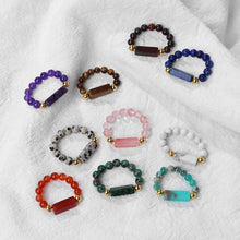 Collection of colorful beaded bracelets on a white fabric background