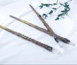 Two decorative sticks with crystal tips on a white background, featuring the brand 'Chakra Stone Runyangshi'.