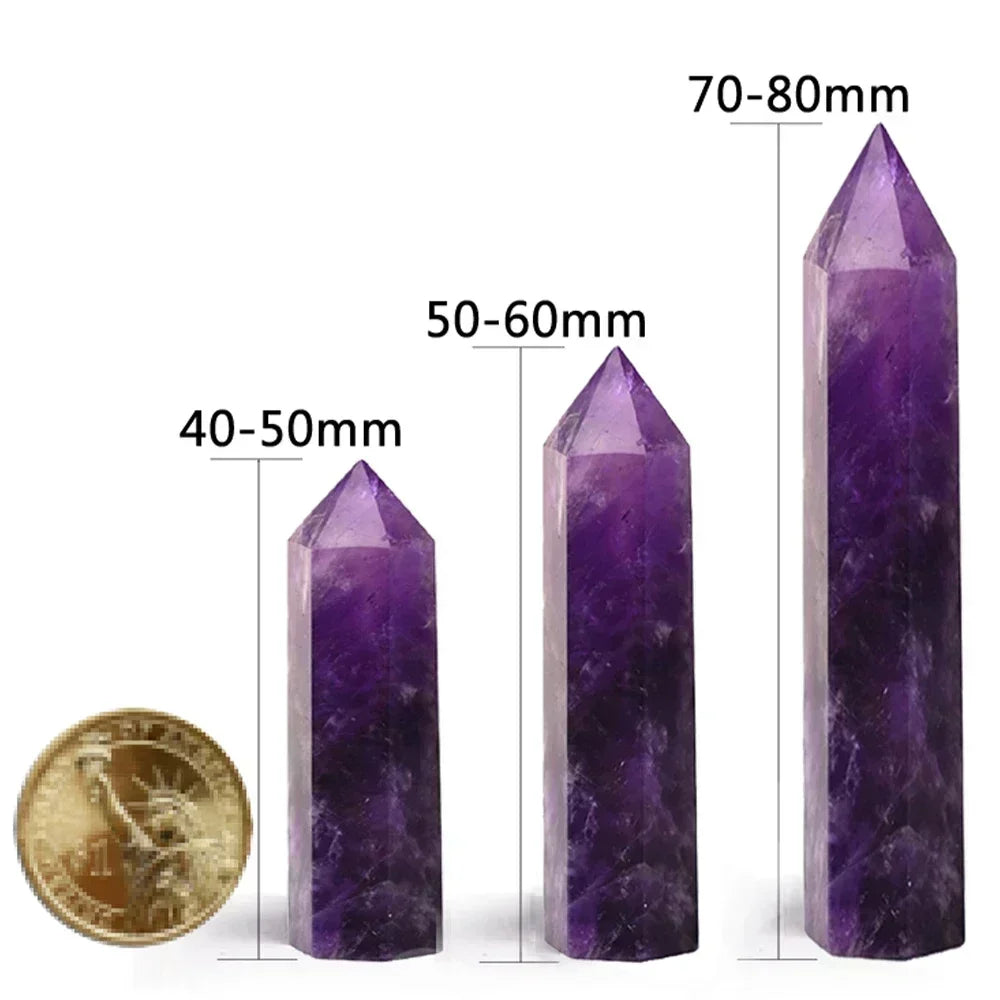 Three purple crystal points with measurements and a gold coin for scale on a white background