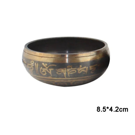 Bronze singing bowl with engraved text on a white background