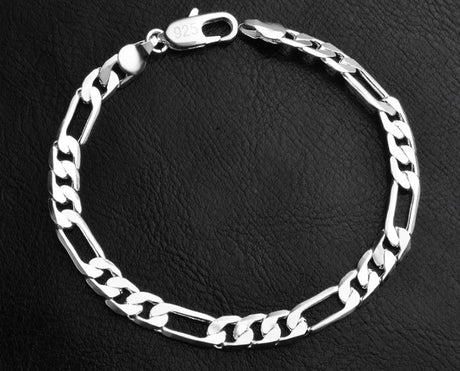 Silver chain bracelet on a black textured background