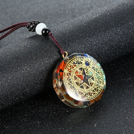 Decorative pendant with intricate design on a dark surface