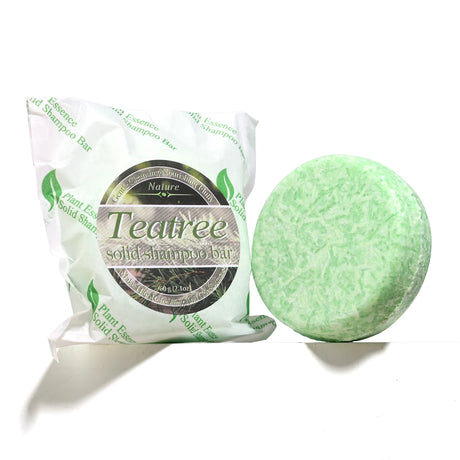 Tea tree solid shampoo bar with packaging on a white background