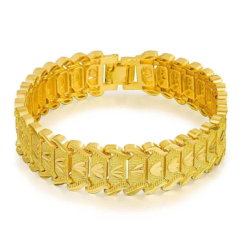 Gold bracelet with intricate design on a white background