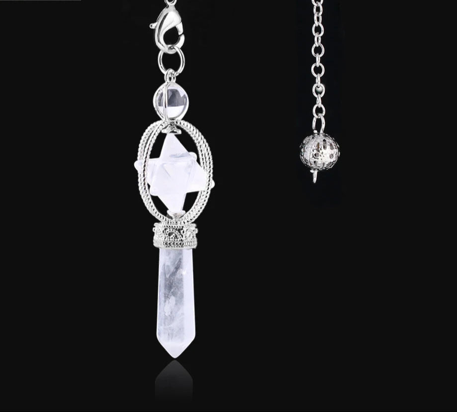 Silver pendant with crystal on a black background