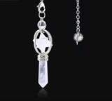 Silver pendant with crystal on a black background