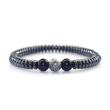 Beaded bracelet with black and gray beads on a white background