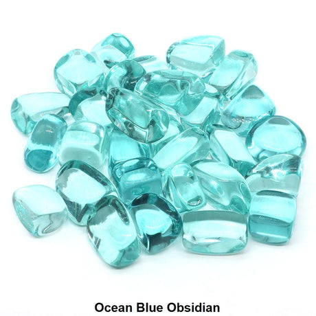 Turquoise blue obsidian stones on a white background