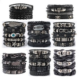 Collection of black leather bracelets with various metal charms on a white background
