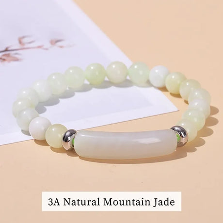 Jade bracelet with silver accents on a beige background