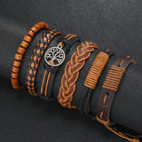 Collection of braided leather bracelets with a central tree-of-life pendant on a dark background