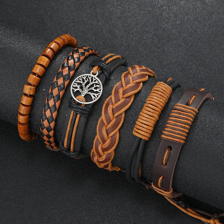 Collection of braided leather bracelets with a central tree-of-life pendant on a dark background