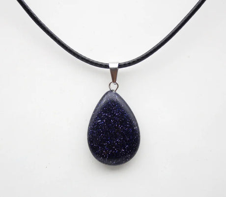 Teardrop-shaped purple pendant on a black cord against a white background