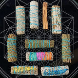Collection of smudge sticks with colorful string on a black geometric background