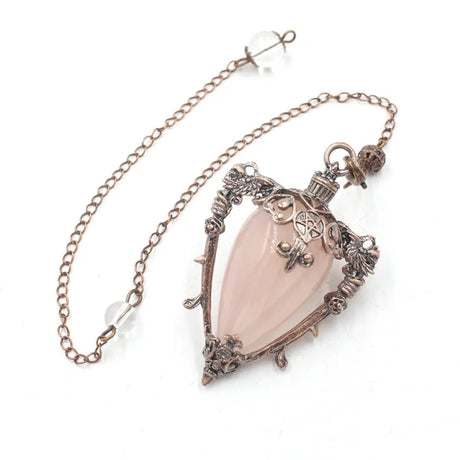 Necklace with a pink teardrop pendant and intricate metalwork on a white background