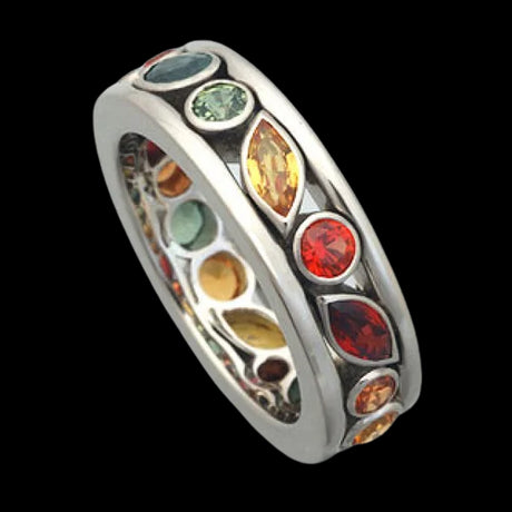 Ring with multicolored gemstones on a white background