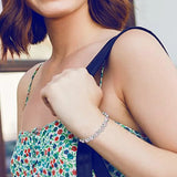 Woman wearing a floral dress and silver bracelet with a blurred background