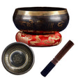 Tibetan singing bowl set with a bowl, cushion, and striker on a white background