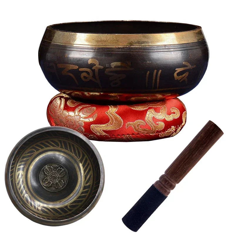 Tibetan singing bowl set with a bowl, cushion, and striker on a white background