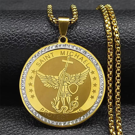 Gold Saint Michael pendant with chain on a black textured background
