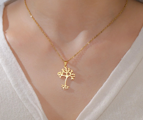 Gold tree-shaped pendant necklace on a model with Lucktune branding.