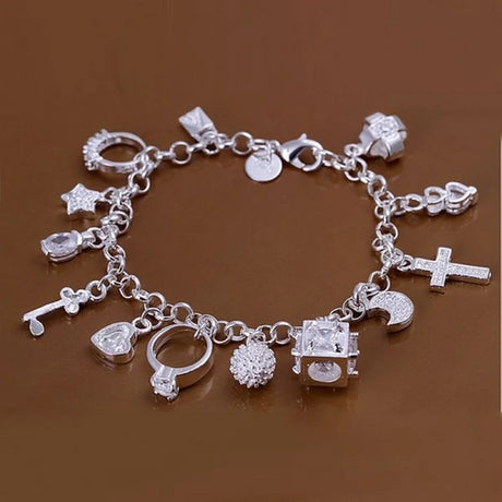 Silver charm bracelet on a brown background