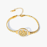 Gold bracelet with a decorative clasp on a white background