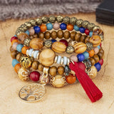 Multicolored beaded bracelet with tassel on a textured surface