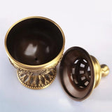 Decorative gold and brown egg-shaped container on a white background