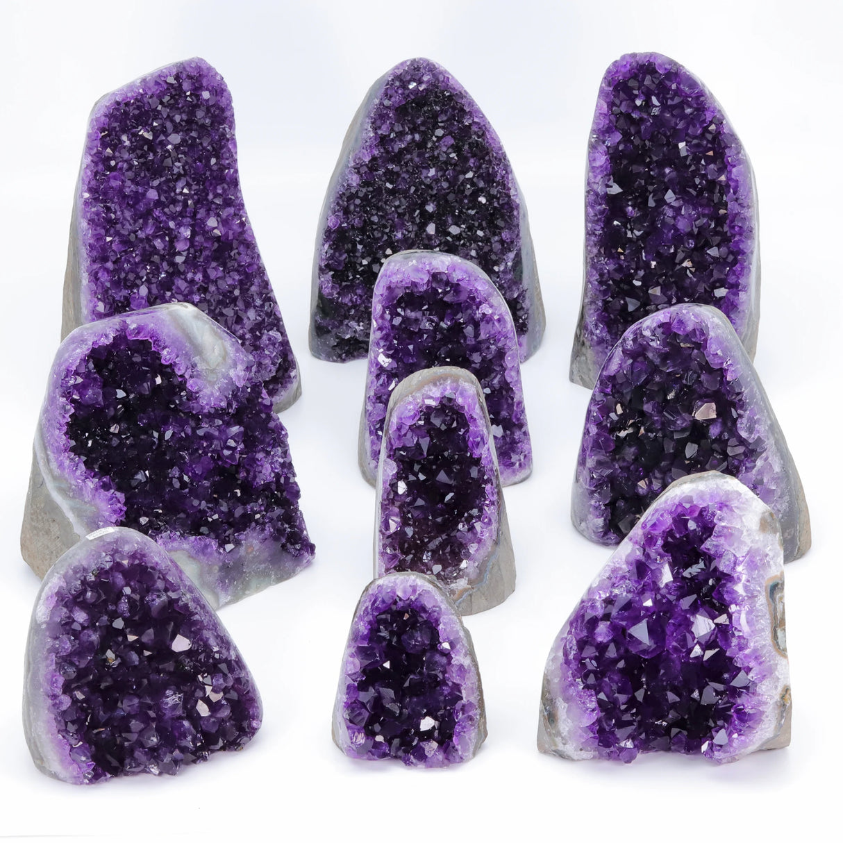 Collection of purple amethyst geodes on a white background