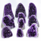 Collection of purple amethyst geodes on a white background