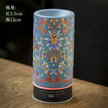 Decorative cylindrical lamp with colorful patterns on a wooden surface