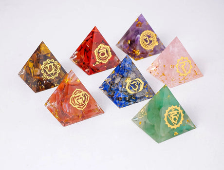 Set of colorful pyramid-shaped chakra stones with gold symbols on a white background, branded 'Chakra Stone Runyangshi'.