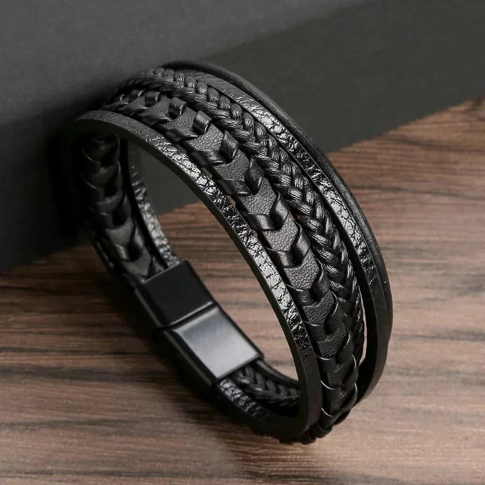 Black braided leather bracelet on a wooden surface