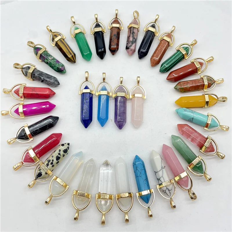 Collection of crystal pendants with gold clasps on a white background