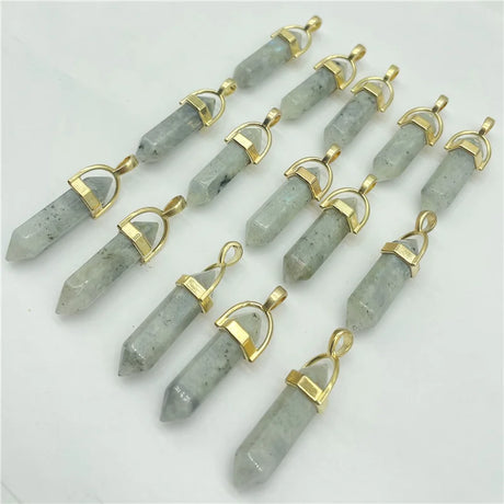 Gray stone pendants with gold accents arranged on a white background