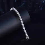 Silver bracelet with clear stones on a dark background