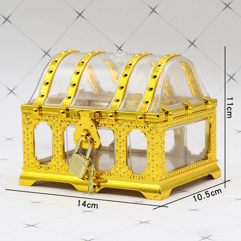 Gold decorative box with clear top and lock on a white tiled background